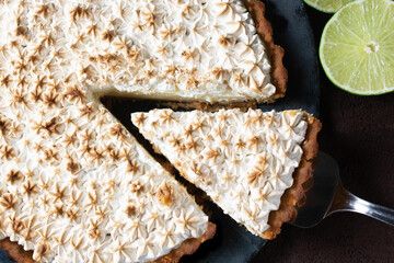 lemon pie with meringue seen from above, slice of pie. Lemon
