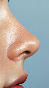 Close up profile of a woman's nose revealing skin texture, pores, and blackheads, highlighting skincare, beauty, and the sense of smell in a cosmetology context