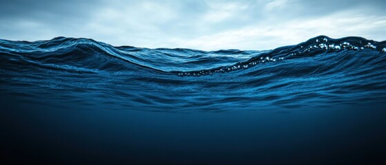 Ocean waves, underwater view, stormy sky, deep blue