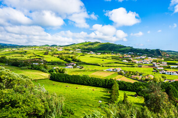 Green farming fields at Almoxarife bay with azure ocean water on coast of Faial island, Azores, Portugal