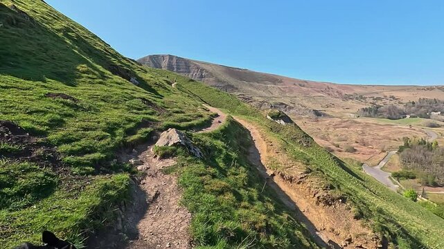 Point of view dog walking border collie peak district England sunny day Mam tor mountain region hills landscapes Holiday in England Casteton