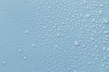 Many water drops on light blue background