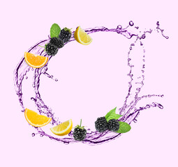 Fresh blackberries, citrus fruits and splash of drink on light background