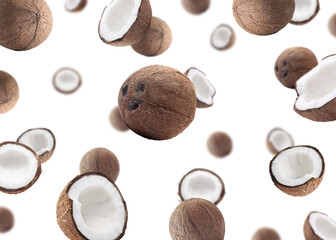 Many fresh coconuts flying on white background