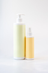 Cosmetic bottles with blank labels on white background