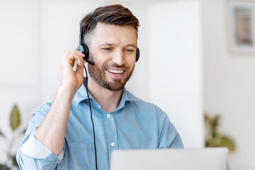 Hotline Operator. Handsome Young Man Customer Support Manager In Headset Working With Laptop...