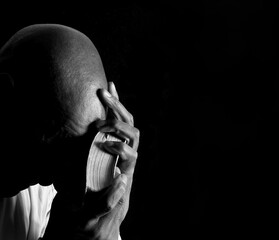 praying to god with hands together Caribbean man praying with black background with people stock photo stock image