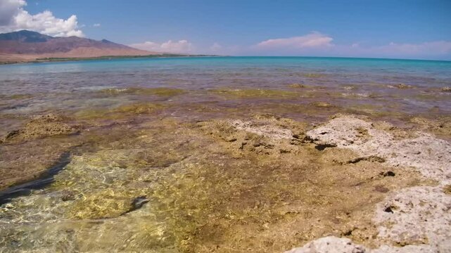 This footage showcases the rugged stone coast of Assyk Kul Lake in Kyrgyzstan, offering a unique perspective on the shoreline and natural landscape.