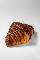 Drizzled Chocolate Croissant on White Background
