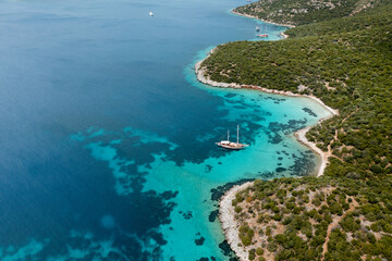 Gulet cruising along beautiful turquoise mediterranean coast in Bozburun Peninsula, Turkey