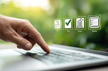 Close-up of a hand interacting with a laptop keyboard, showcasing digital forms and checks in a serene outdoor setting