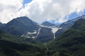 Scenic Landscape Of High Caucasus Mountains In Russia, Featuring Rocky Peaks, A Glacier Tongue...