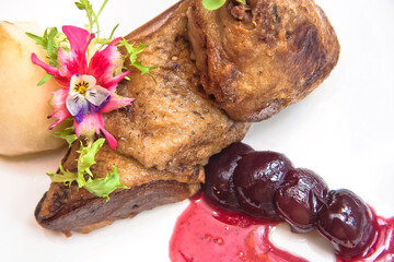 Duck in cherry sauce, duck leg with roasted pear in cherry sauce, gourmet food