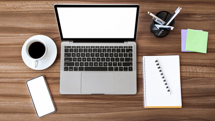 Office Workplace. Flat lay of laptop and cell phone with white monitors for mock up, notebook and...