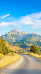 Naklejka premium Serene mountain road winding through lush green hills under a blue sky 