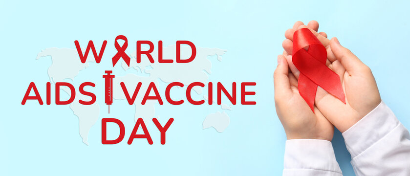 Female hands with red ribbon on blue background. Blood Cancer Awareness Month