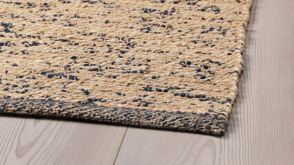 Closeup of handmade flatwoven rug on wooden floor.