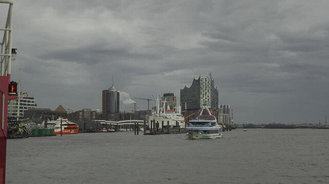Discover Hamburg waterfront with its iconic Elbphilharmonie, bustling harbor and historic maritime charm. Vibrant mix of modern architecture, ships and scenic river views in Germany largest port city