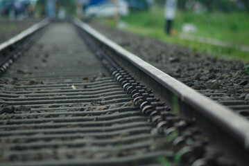 Railroad track detail close up, Railroad Tracks Perspective. Long iron railroad tracks surrounded by gravel