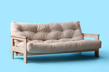 Comfortable white sofa on blue background