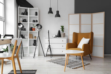 Interior of photographer's office with workplace, armchair and equipment