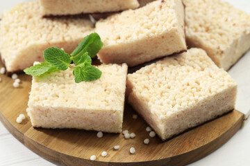 Delicious puffed rice bars and mint on table, closeup