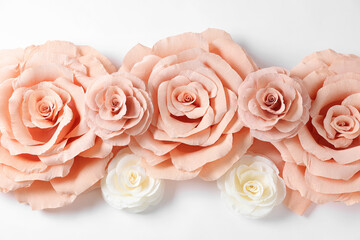 Beautiful paper flowers on white background, flat lay