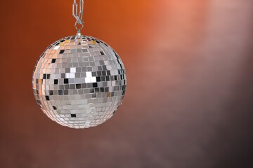 One shiny disco ball on color gradient background, space for text