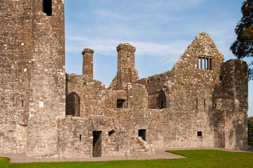 The old castle is in ruins, with a large stone wall surrounding it