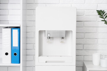 Modern water cooler in light office, closeup