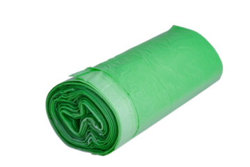 Garbage bags in a roll, green color, isolate. Recycled material, garbage bag on a white background.