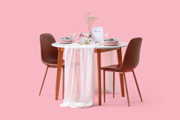 Restaurant table for two with plates, flowers and heart-shaped gift box on pink background
