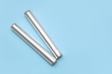 Aluminium foil rolls on blue background