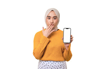 Beautiful amazed Asian girl wearing hijab holding mobile phone with blank white screen, covering mouth with hand isolated on transparent background, mockup, copy space