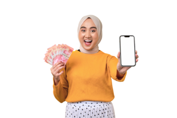 Beautiful amazed Asian girl wearing hijab showing mobile phone with blank white screen, holding cash money isolated on transparent background, mockup, copy space
