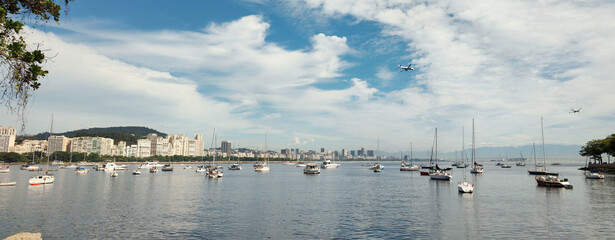 Rio de Janeiro Urca neighborhood sea beach water reflection sky cloud blue cloud landscape horizon boat sailboat kayak transport leaf tree close nature beautiful life vacation