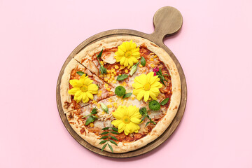 Board with pizza and beautiful flowers on pink background