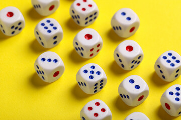 Dices with red and blue pips on yellow background, closeup