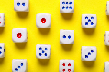 Dices with red and blue pips on yellow background