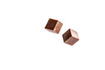 Two chocolate cubes floating in dark space offering a sweet treat for those with a sweet tooth craving
