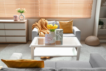 Interior of living room decorated for Mother's Day with sofas and table