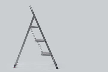Metal stepladder on light background