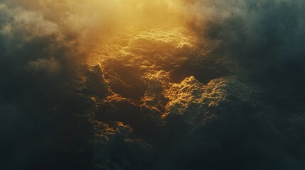 Naklejka premium Golden light illuminates a textured landscape with dark moody surroundings creating a dramatic contrast