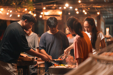 Asian people Enjoying Summer BBQ Party, Cooking Delicious Meat Grill for Friends, Sharing Fun and Happy Moments Together, Embracing a Lifestyle of Friendship Dinner at Night