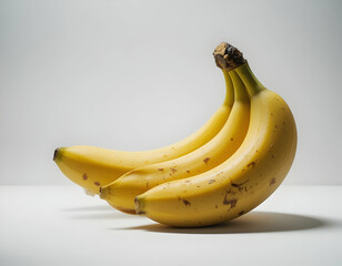 Ripe Yellow Bananas with Brown Spots on White Background