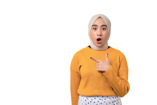 Beautiful shocked Asian girl wearing hijab pointing finger at empty copy space isolated on transparent background