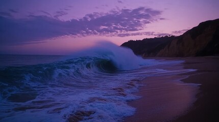 Fototapeta premium A large ocean wave crashes onto a sandy beach during sunset time