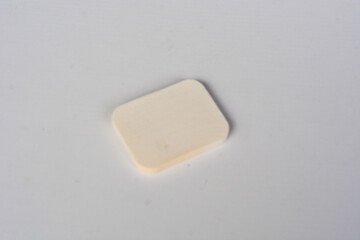 A set of makeup sponges on a pink background close-up.