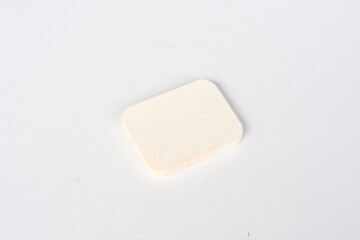 A set of makeup sponges on a pink background close-up.