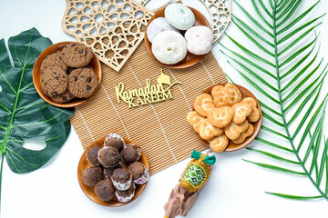 Top View Of Assortment Sweet Cookies And Dates Fruit On Wooden Plate With Islamic Decoration
